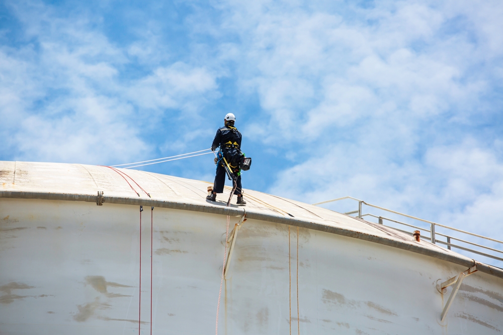serviceman on industrial tank